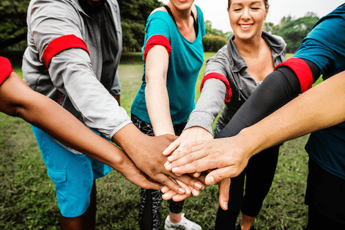 People holding out hands in a huddle