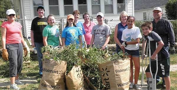 Group of volunteers cleaning up lawns.