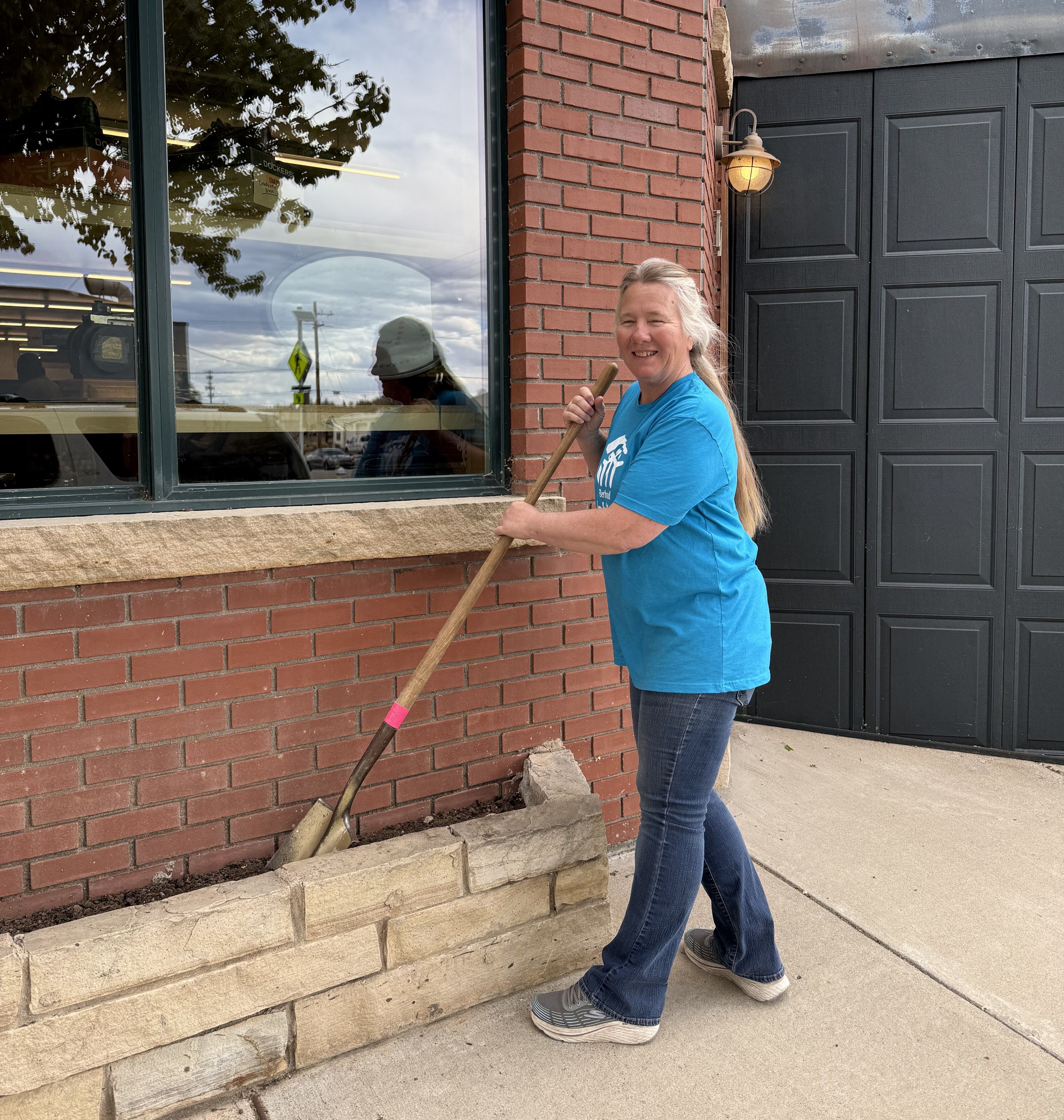 Christine taking care of the garden beds at the restore