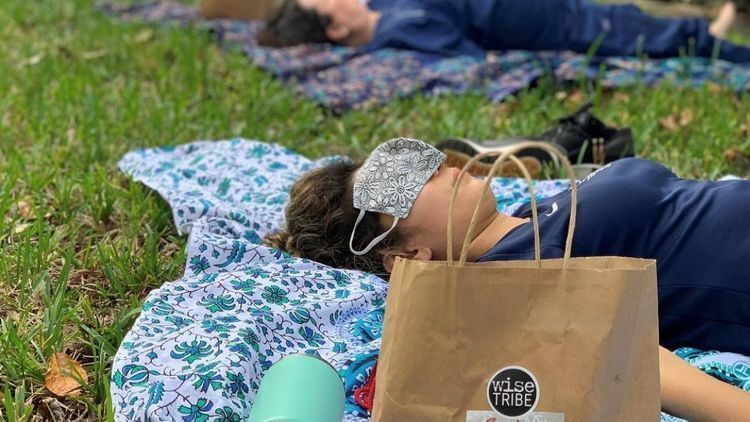 Teachers laying outside to meditate