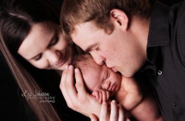 Parents with their newborn who has Down syndrome.