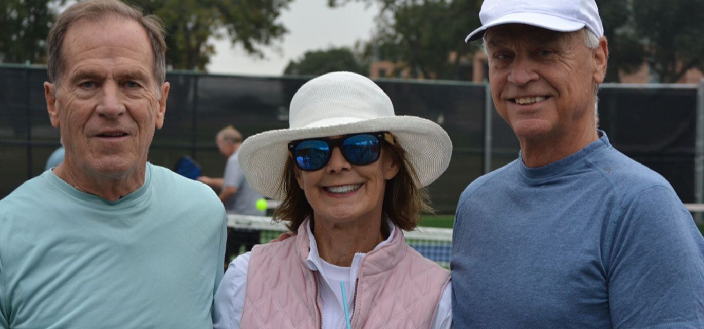 Three people at pickleball tournament