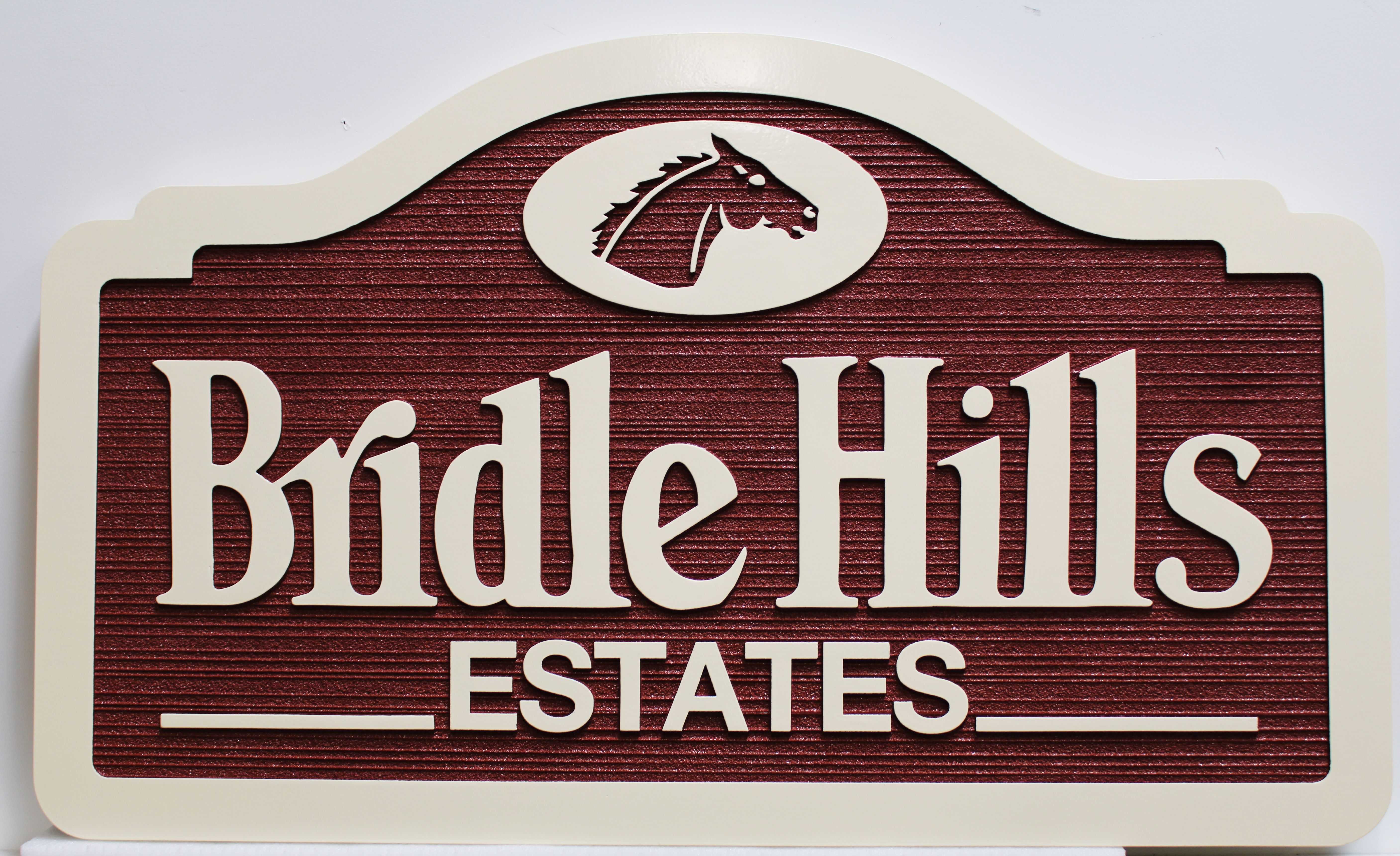 K20403 - Carved and Sandblasted Wood Grain    Entrance Sign for "Bridle Hills Estates", with  a Horse's Head  Logo as Artwork