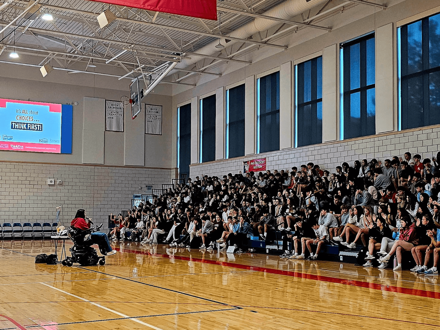 students listening to speaker in wheelchair
