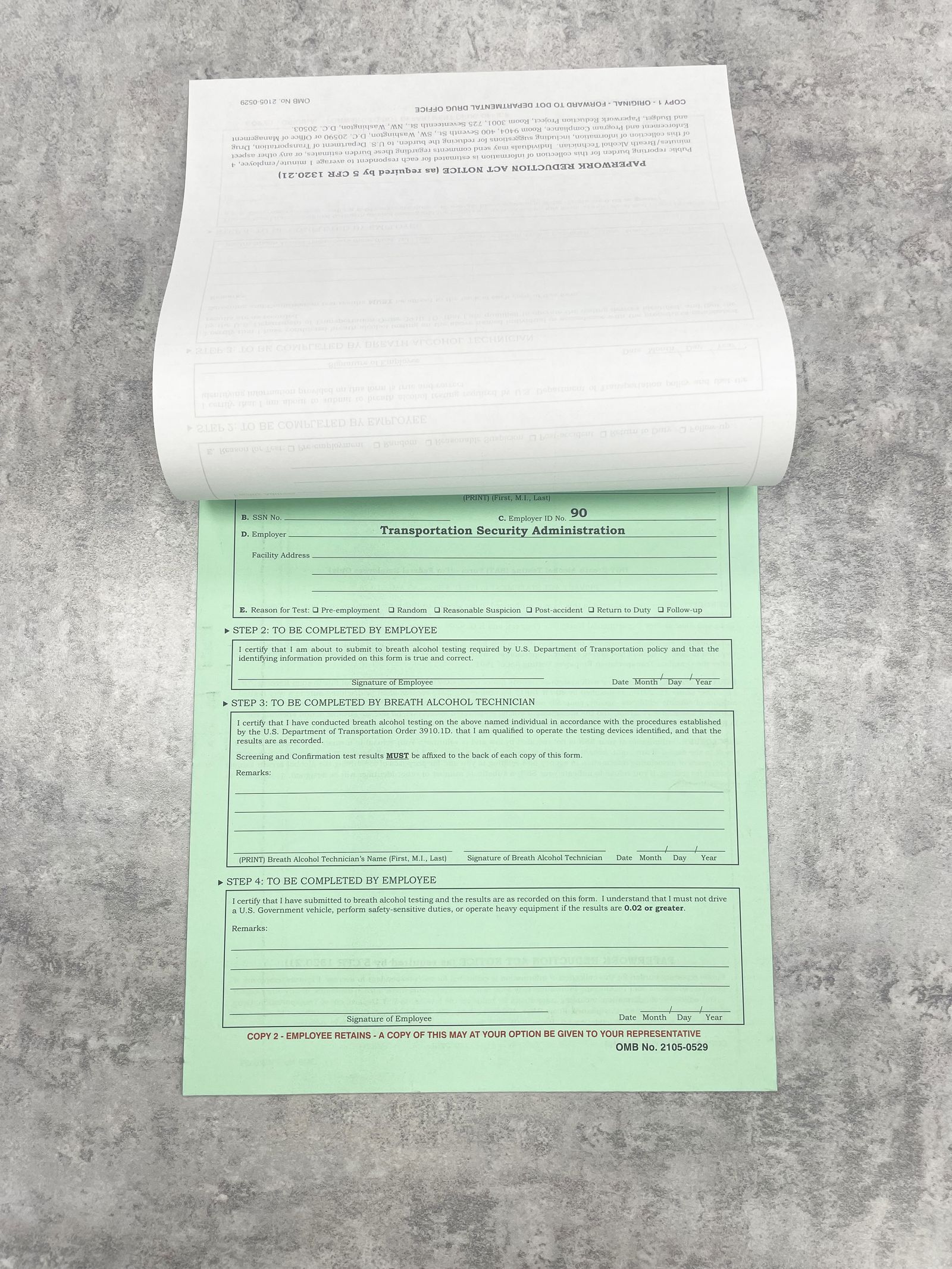A two-part carbonless form flipped open to reveal the second page.