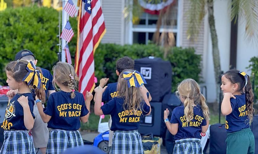 Picture of the Spirit Squad performing, in their t-shirts with “God’s Got My Back” printed on the back.