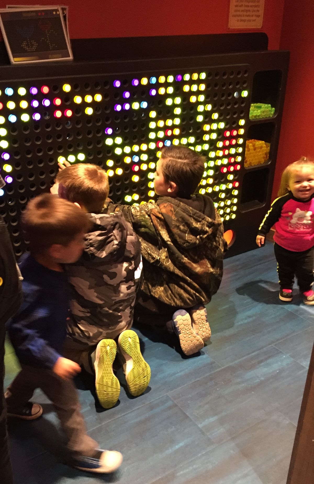 Boy and girl playing with a giant light bright in the Smoky Hill Museum exhibit The Curiosity Shop.