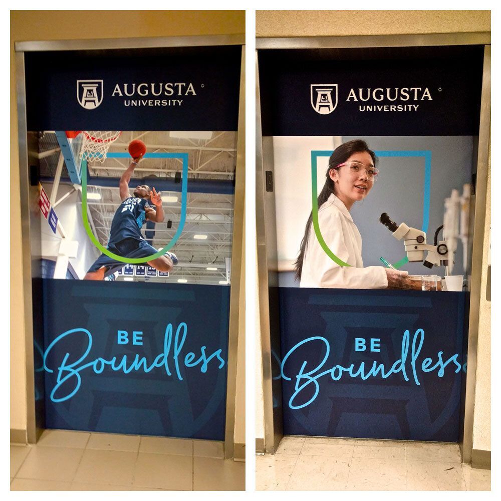 Branded elevator door wrap graphics installed at Augusta University