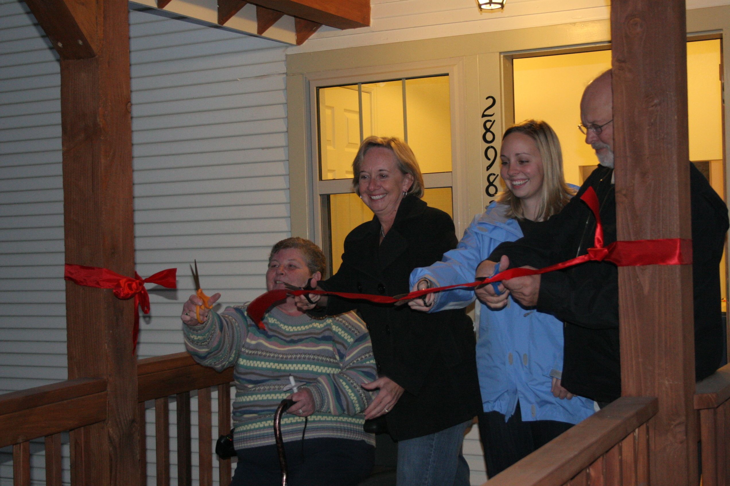 Family ribbon cut at house blessing