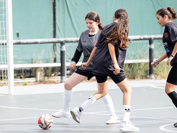 Girls practice footwork drills during soccer practice.