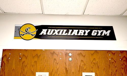 Descon helps you brand your facility by including bold colors and logos in your room location signs.