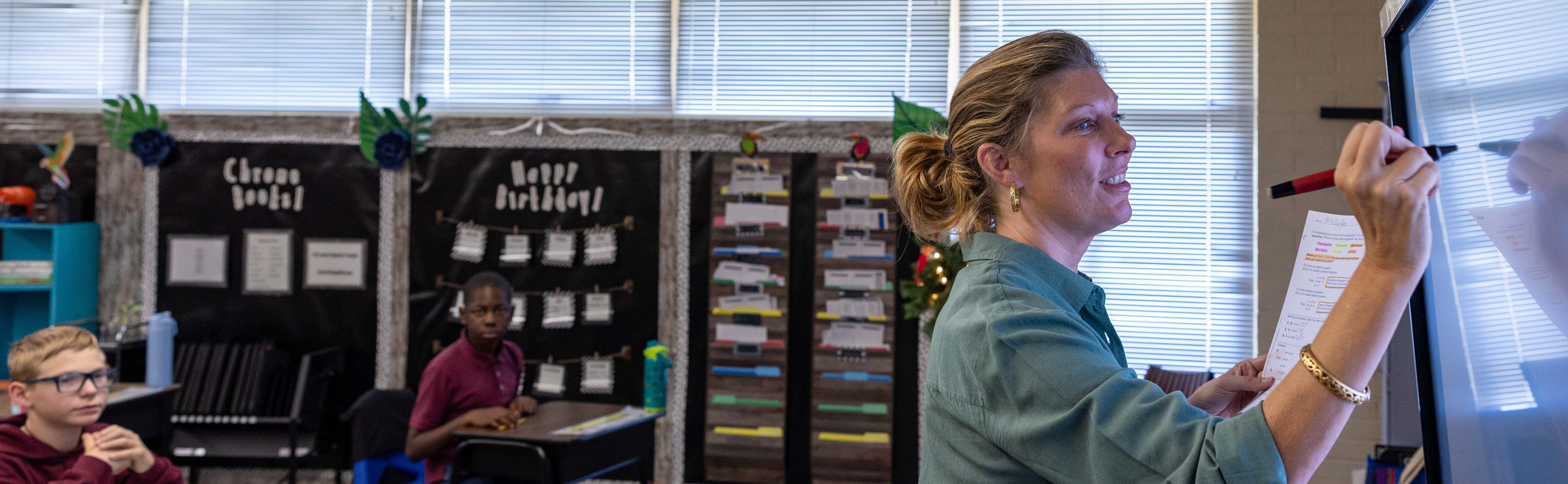 Teacher working at a white board