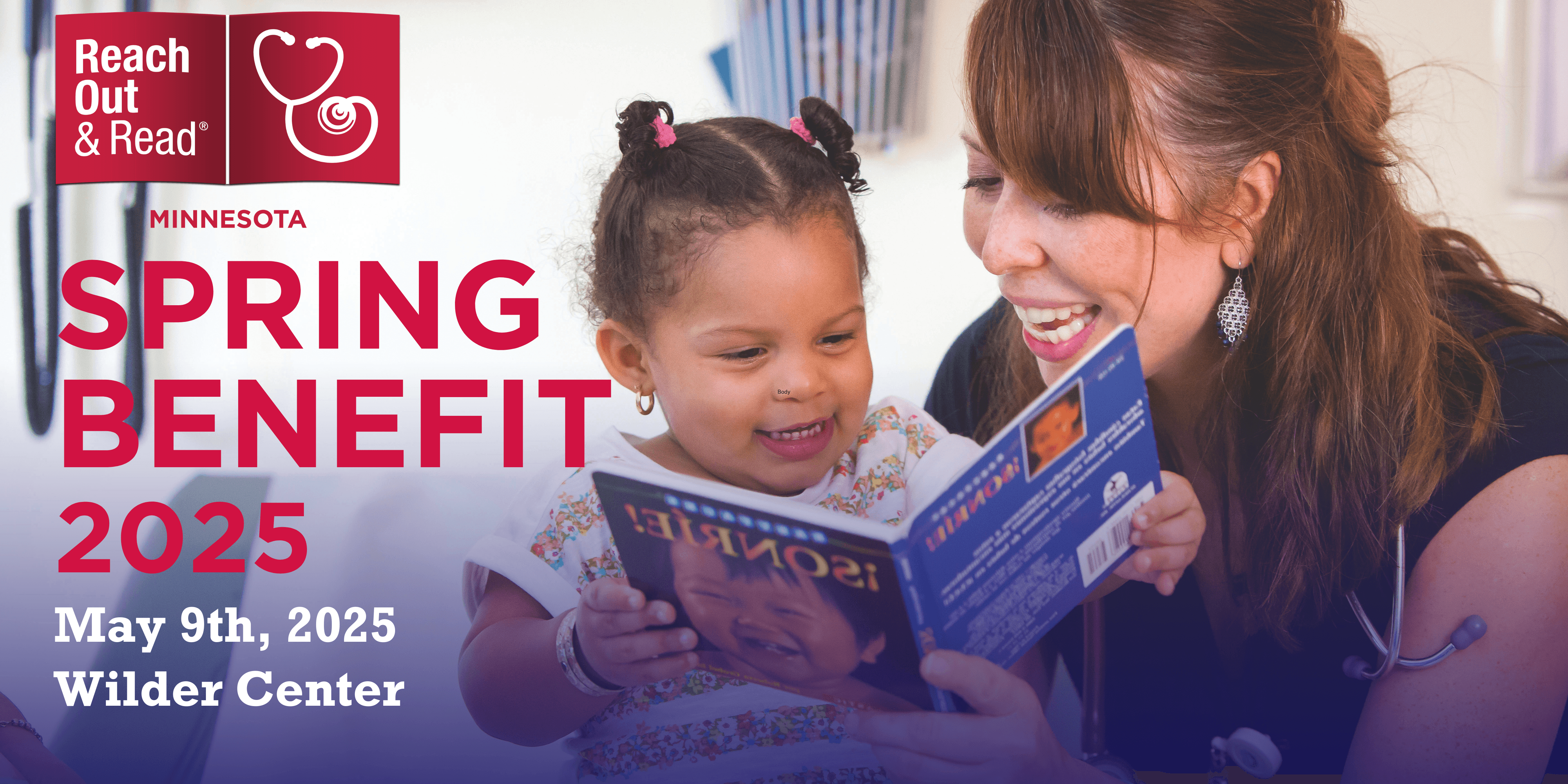Clinician and toddler girl smile at book together