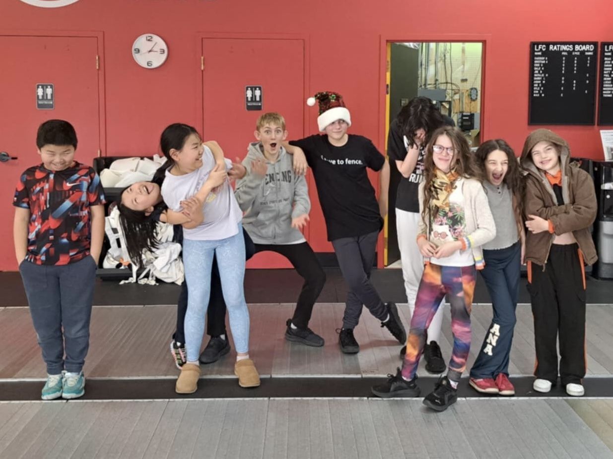 A group of youth fencers pose for the camera