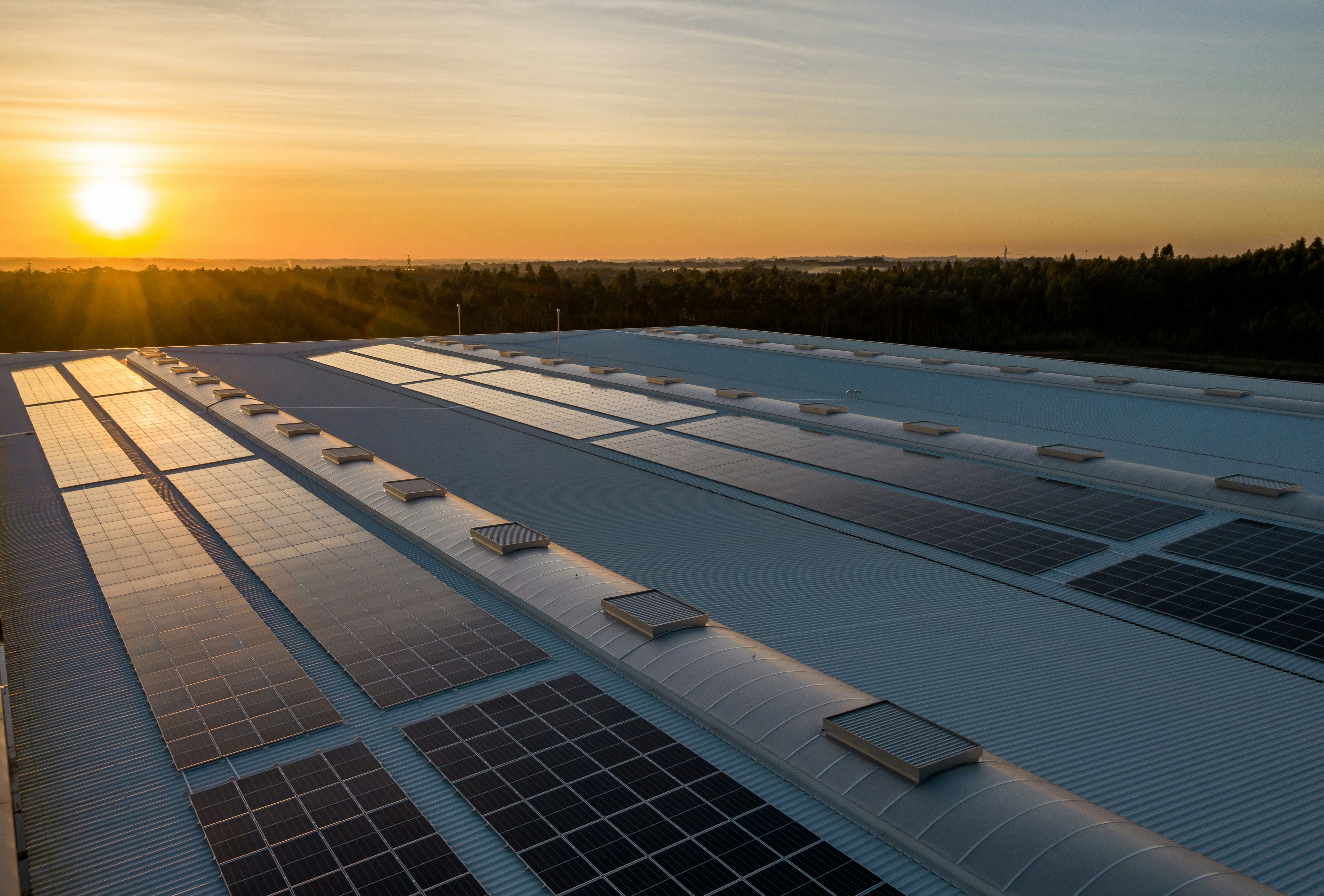 Photo of rooftop solar panels at sunset