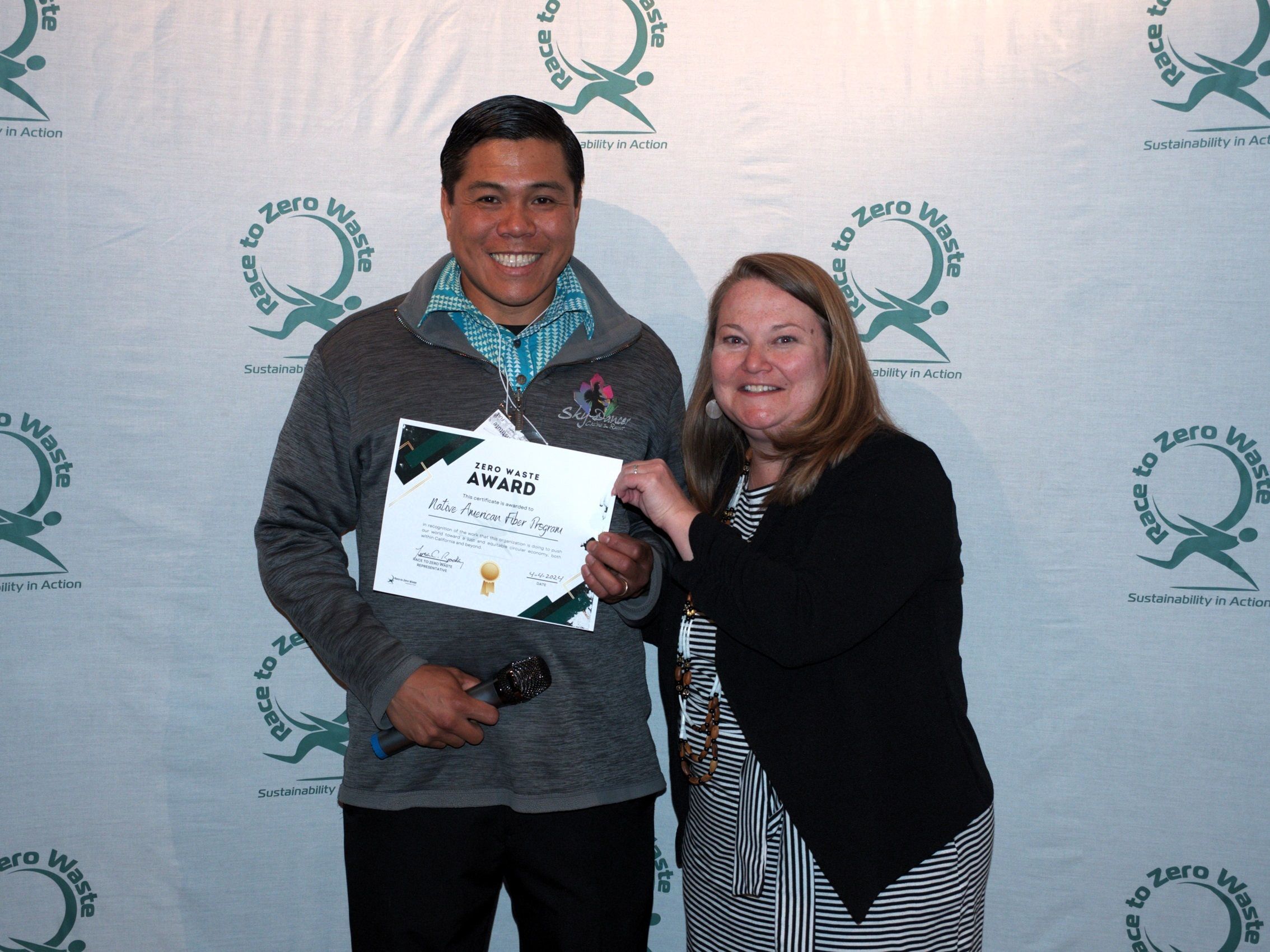 Fred Briones accepts the Zero Waste Award from Teresa Bradley 