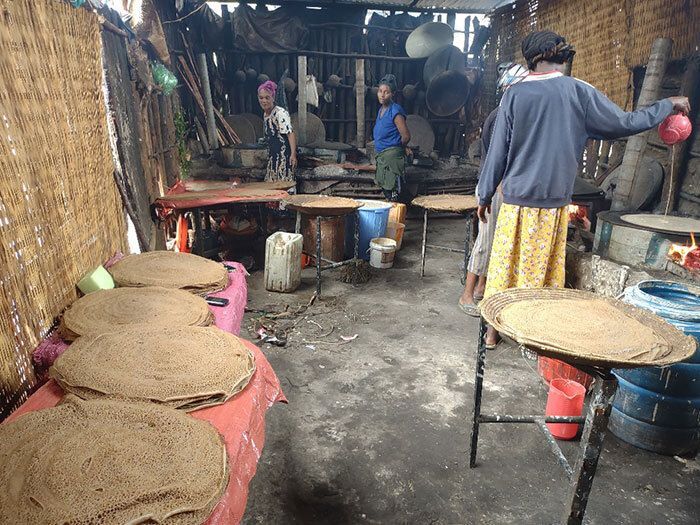 Injera Cooking on both wood fire stoves and electric mitads