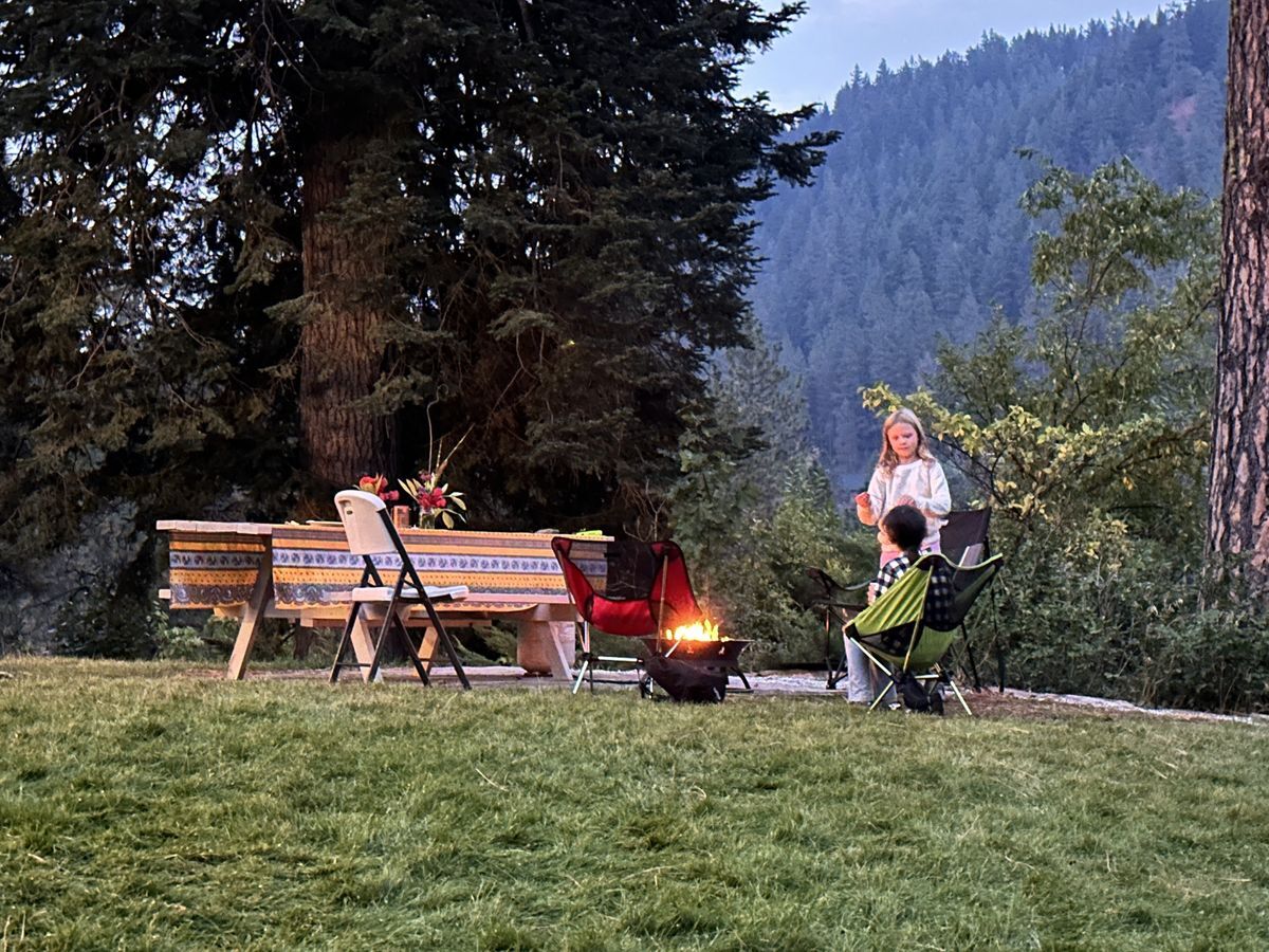 Kids sitting around a fire pit during 2025 Sunset & S'mores
