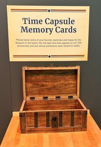 Wooden chest with the label "Time Capsule Memory Cards" above it.
