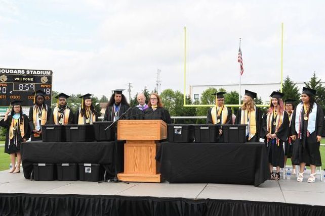 Principal and students on graduation stage