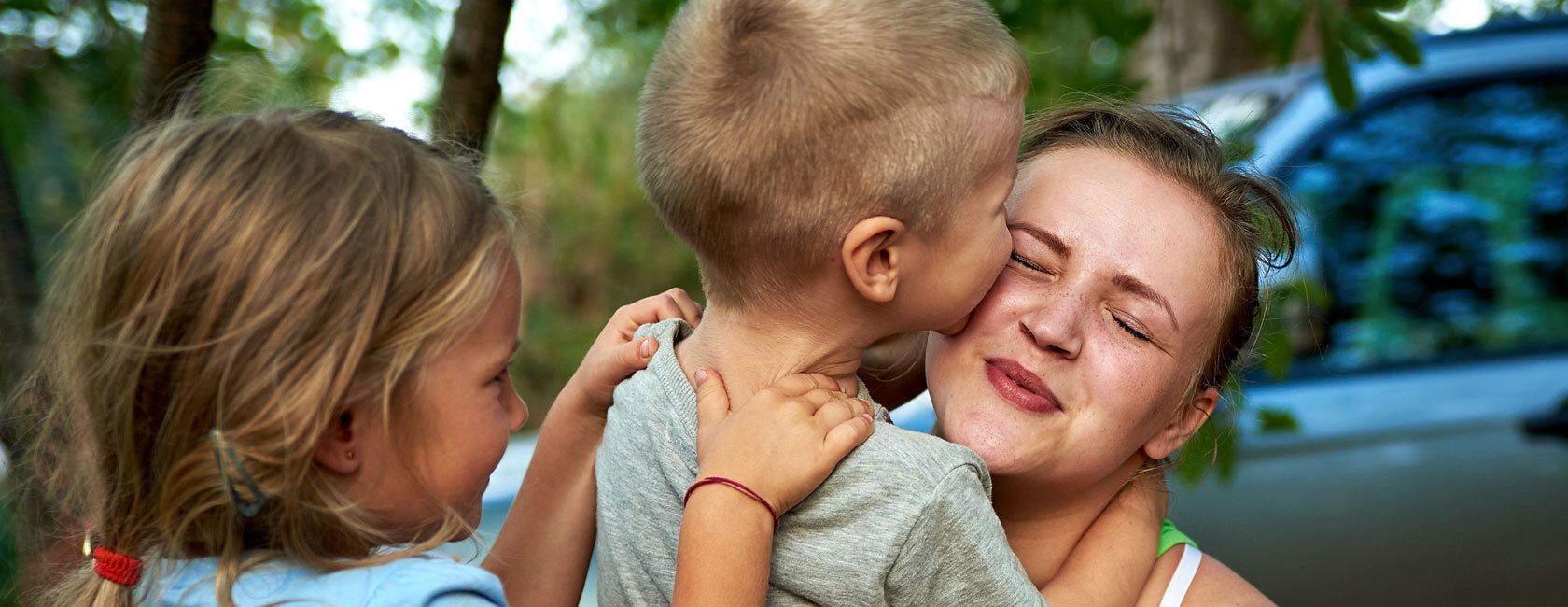 Kids embracing mother
