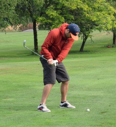 Sean looks at ball as he swings