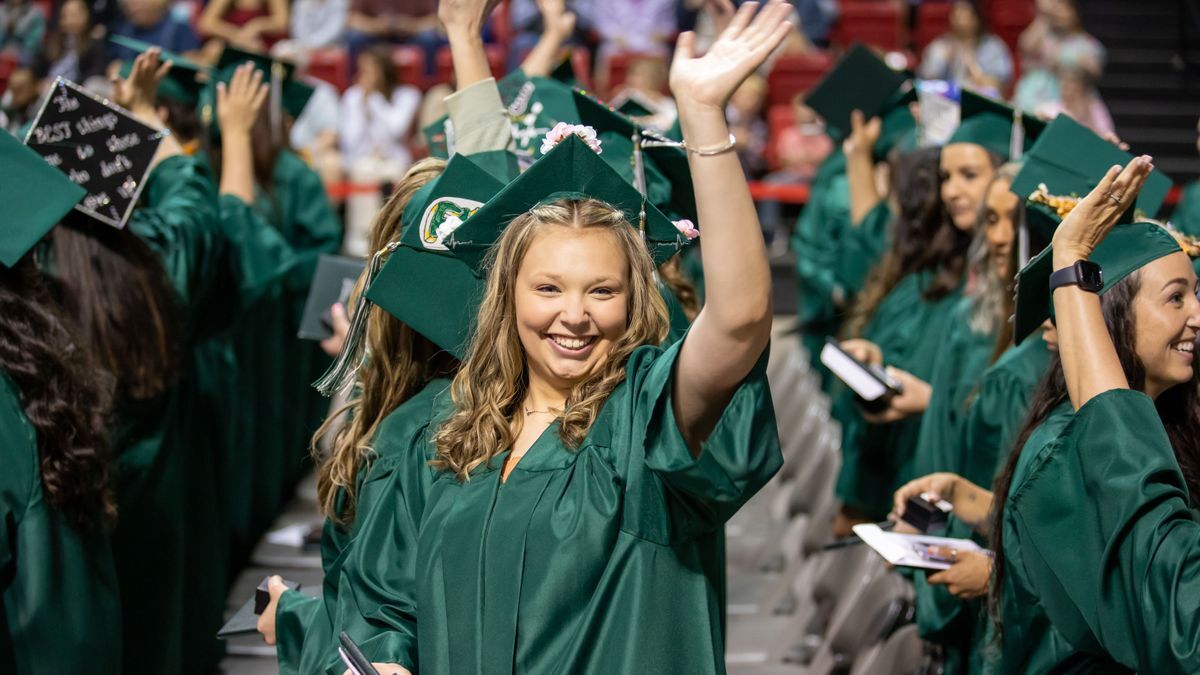 Happy waving graduate