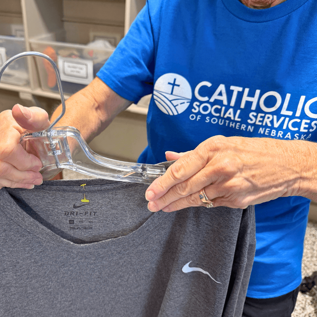 CSS St Louise Gift & Thrift Store volunteers sort merchandise in back of house