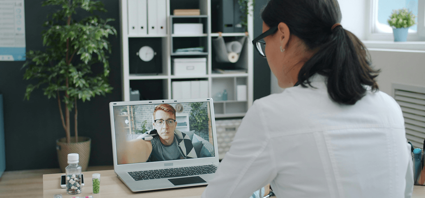 Telehealth provider with patient on a computer screen