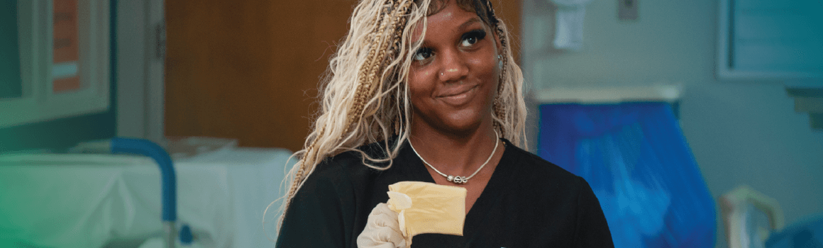 smiling nursing student with sterile gloves