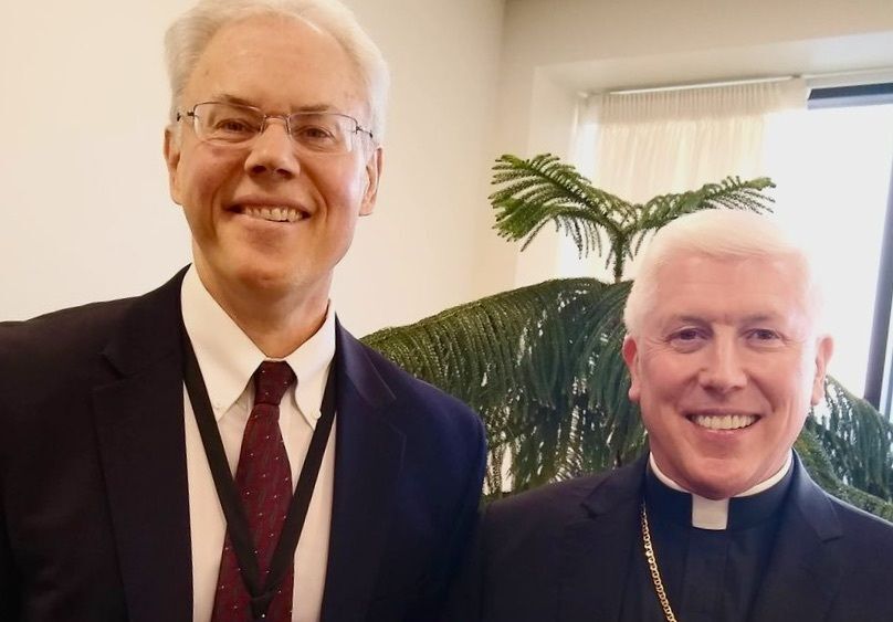 Rodney Schuster, Executive Director of Catholic Charities Diocese of Toledo and the Diocese of Toledo's Bishop Daniel E. Thomas.