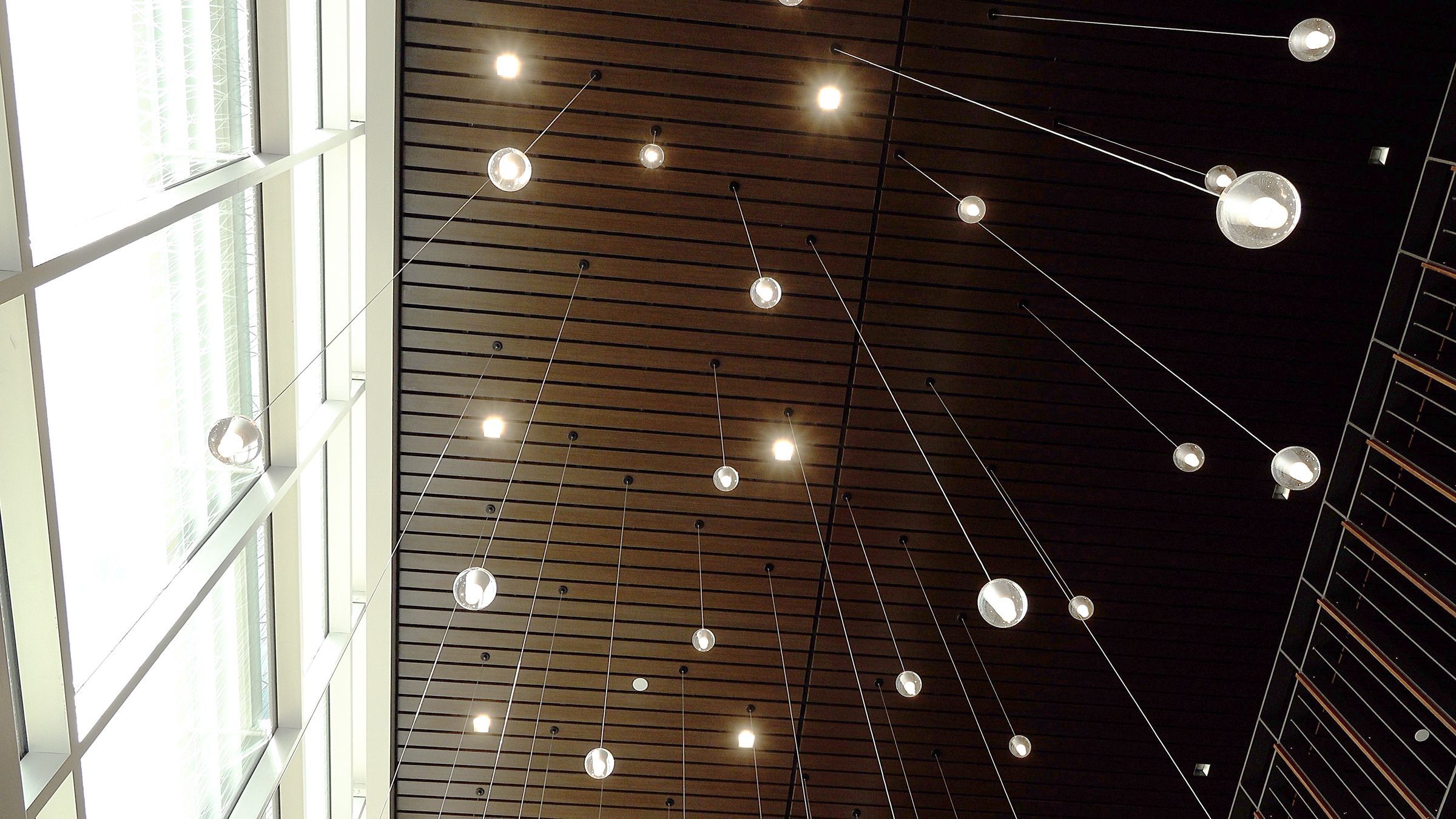 photo of light fixture above grand staircase