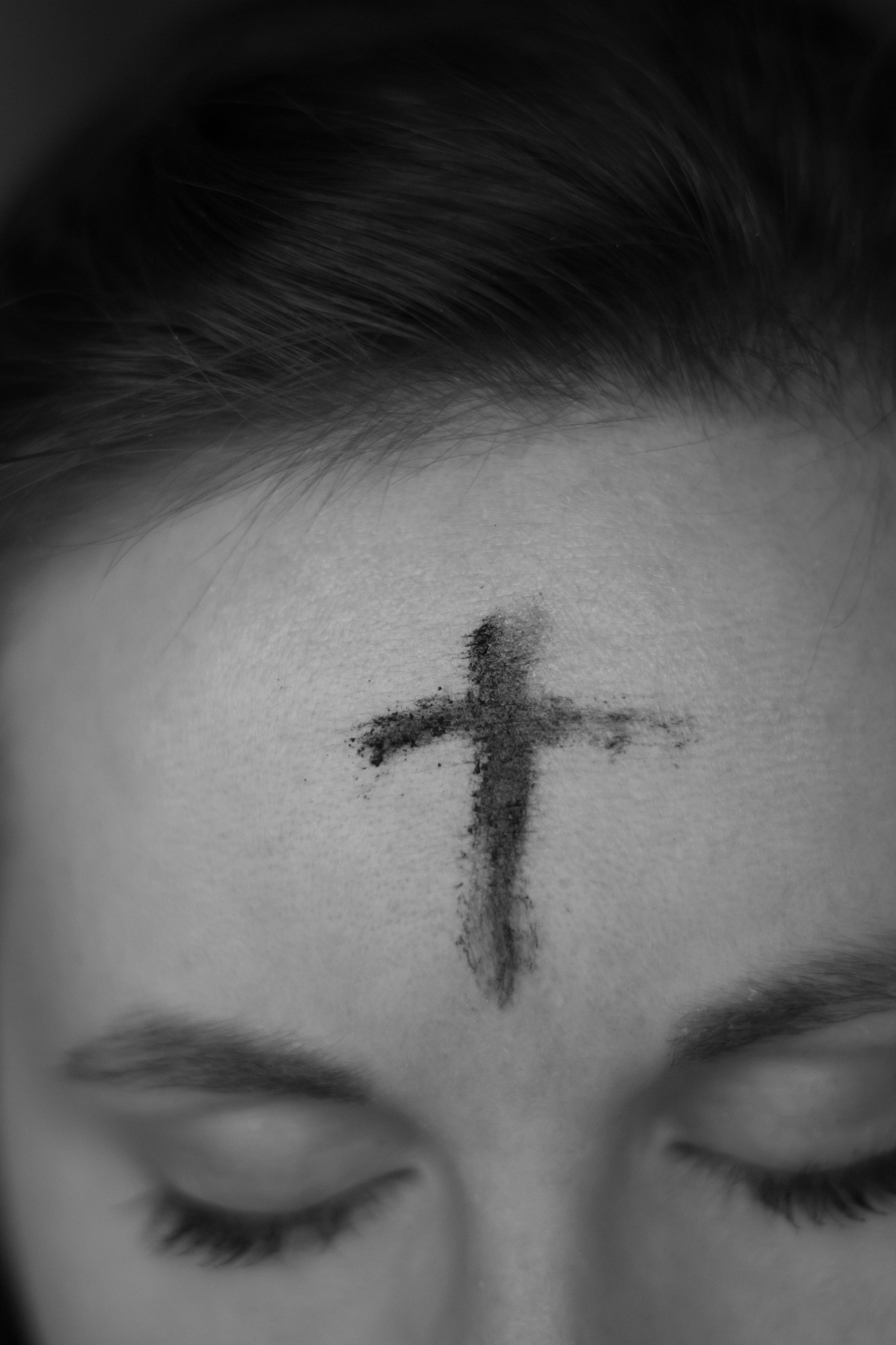 Ashes on a woman's forehead in black and white