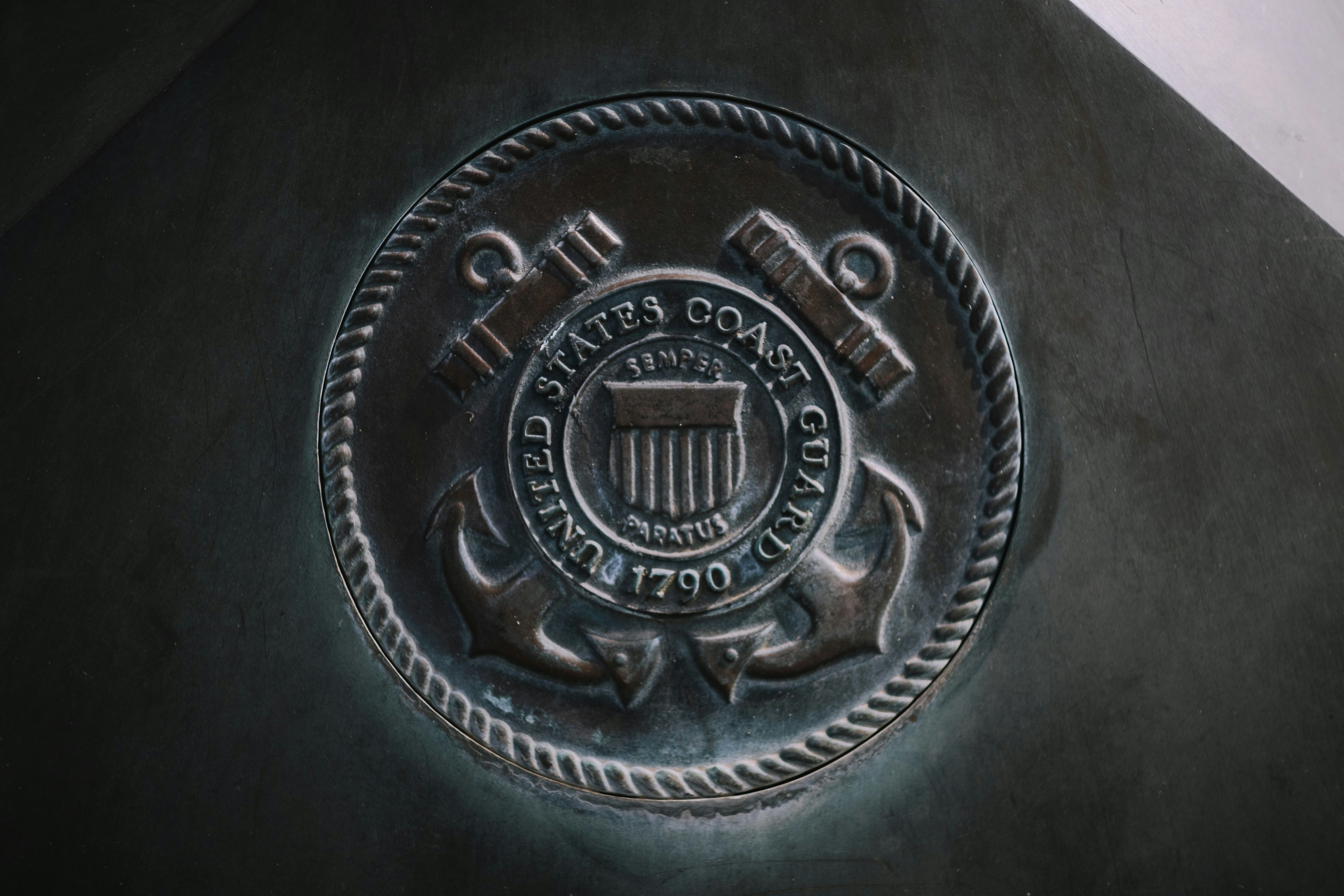 A child is held by an adult in a camouflage uniform