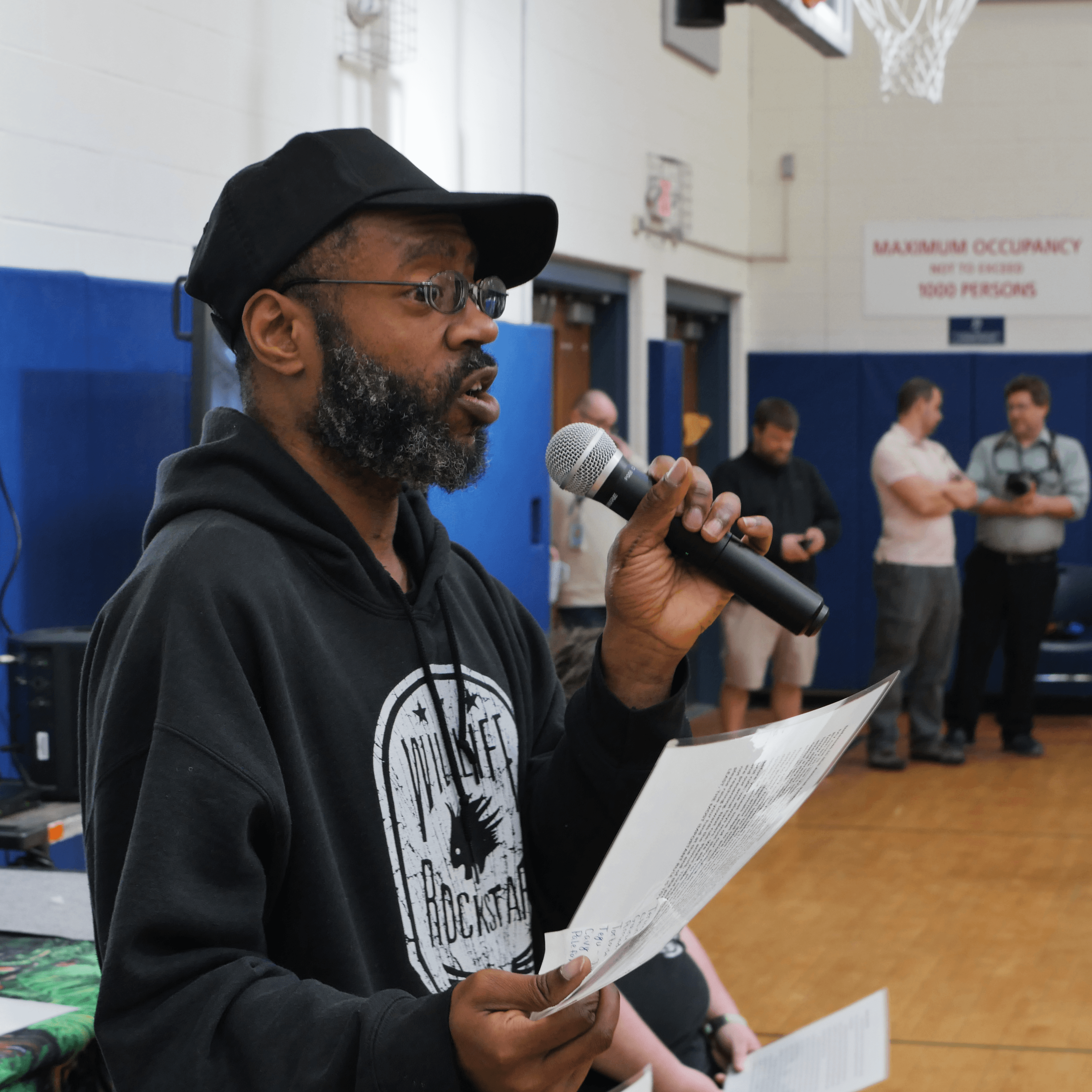 Justin stands and presents to a school