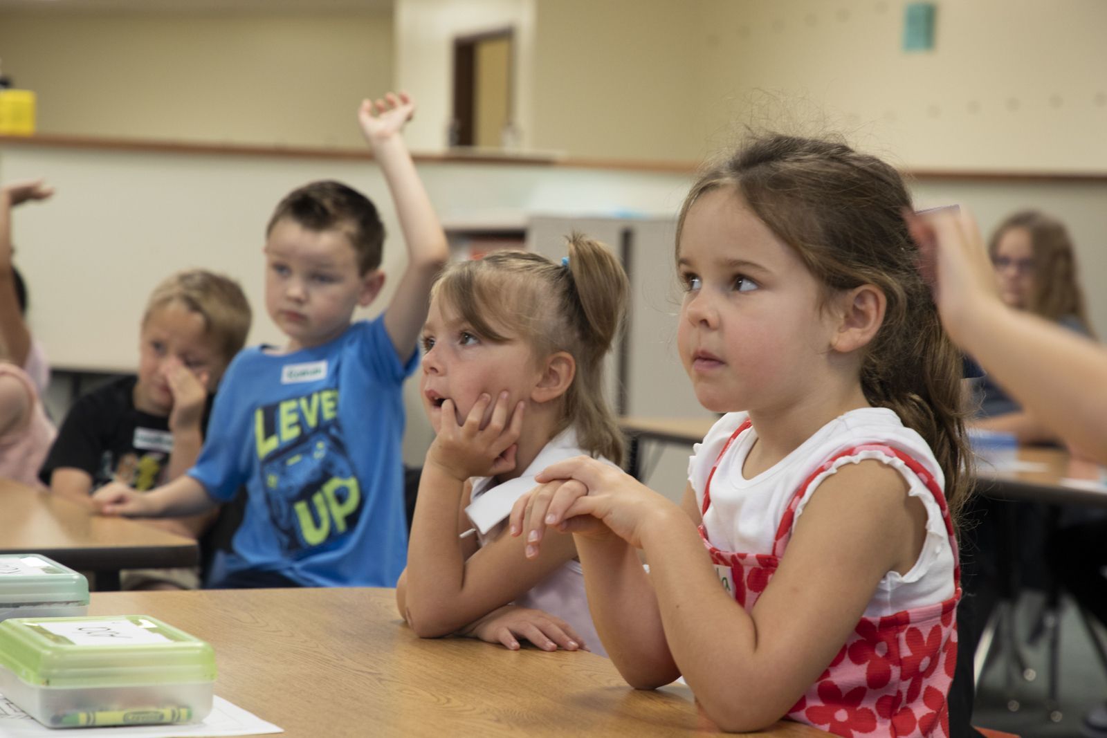 Three elementary age students focusing hard. 