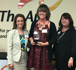 Sara receives her award from Lori Roper from The Arc of Jefferson, Clear Creek and Gilpin Counties