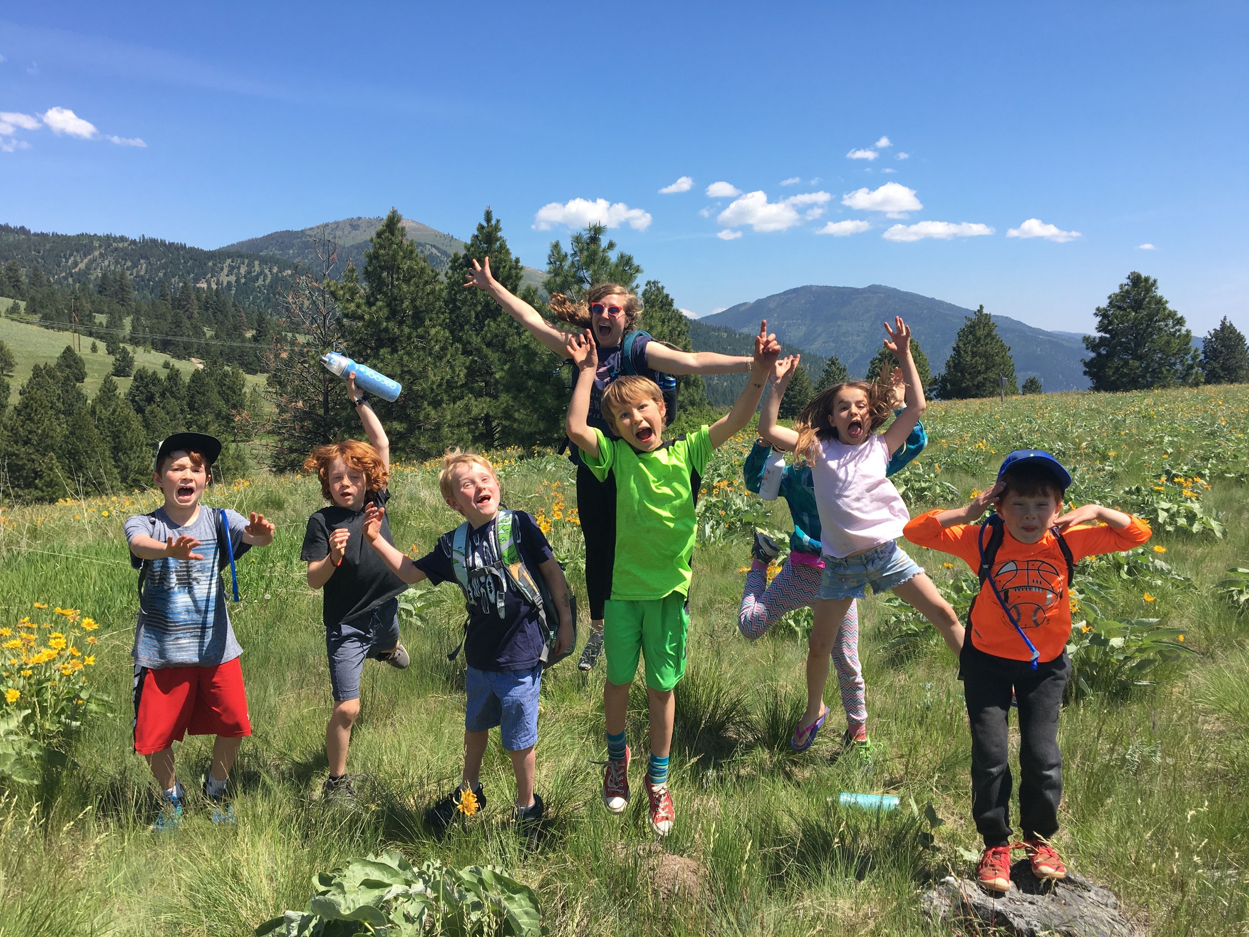 Group of students jumping with joy in nature