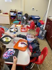 Preschoolers playing at a sandtable.