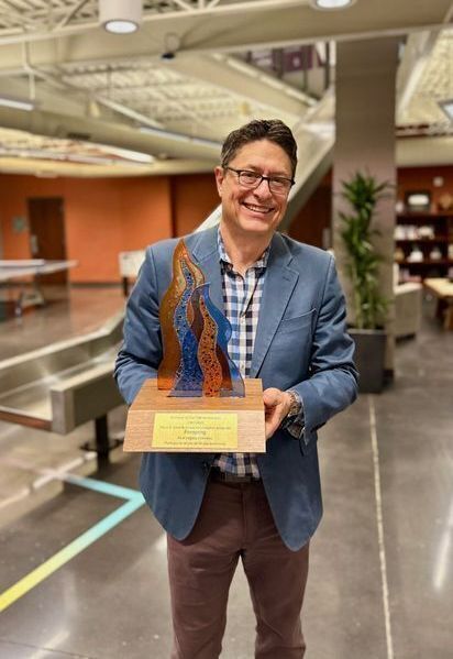 Jay Wilkinson holding Firespring's Nebraska Legacy Business Award