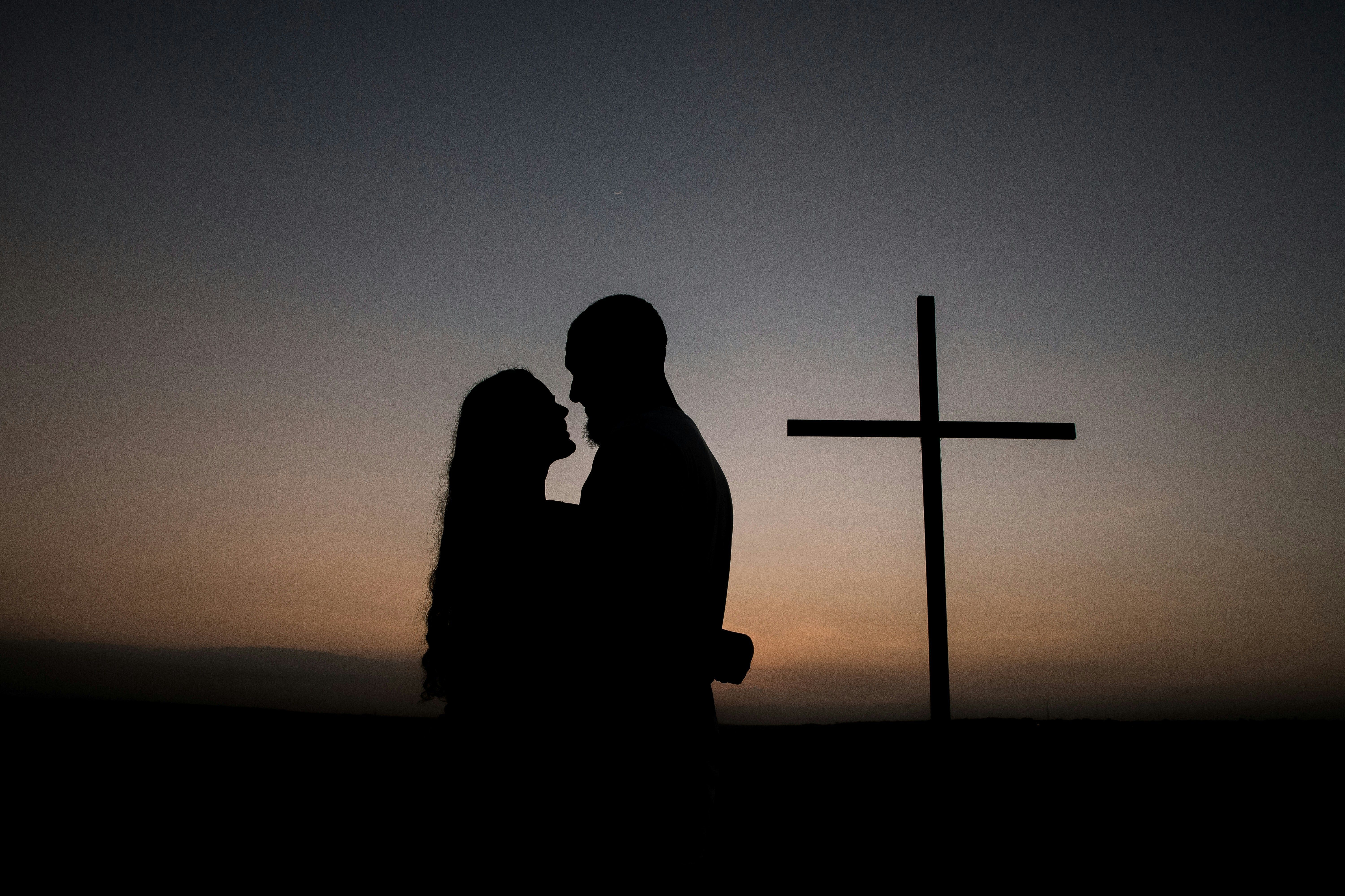 couple with cross in background