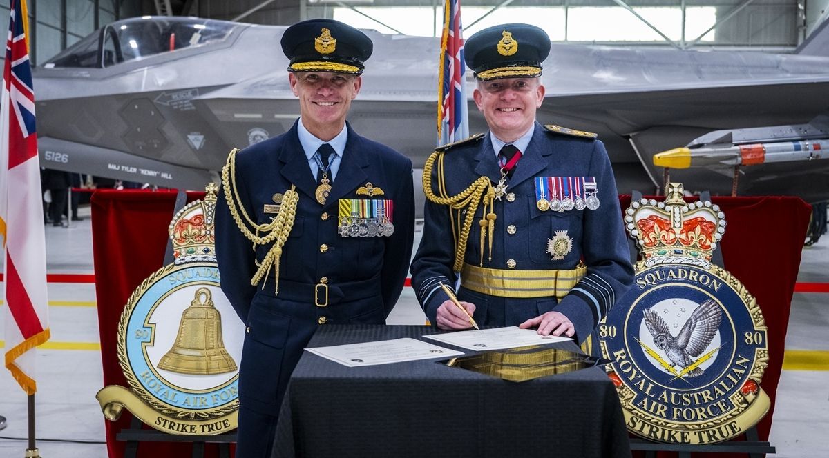 EP-1024 - Carved 2.5-D Plaques of UK and Australian Air Force Unit Seals Shown in a Military Ceremony
