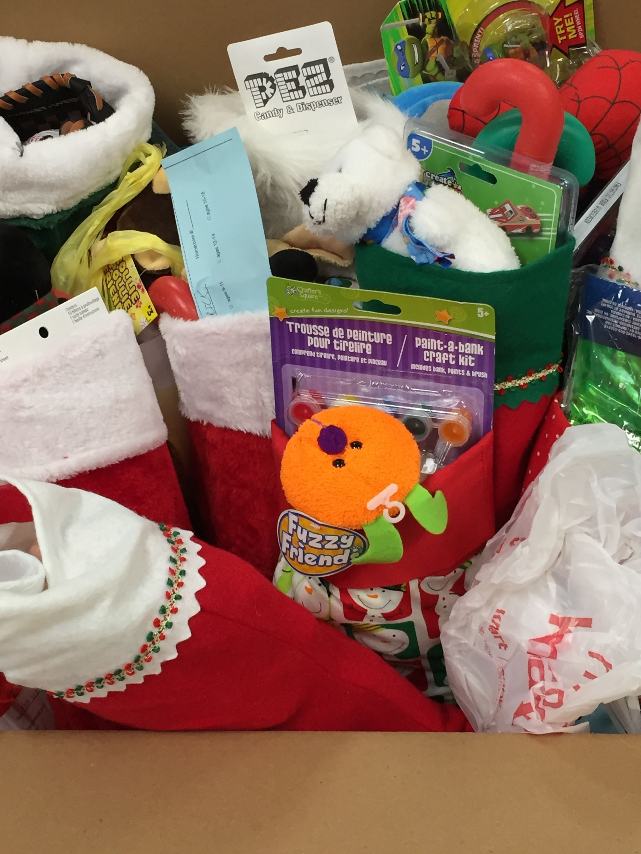 A couple of stockings are shown, stuffed with toys and candy.