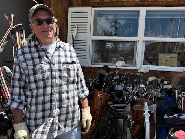 Volunteer at the Blue Spruce Habitat ReStore with donated golfclubs