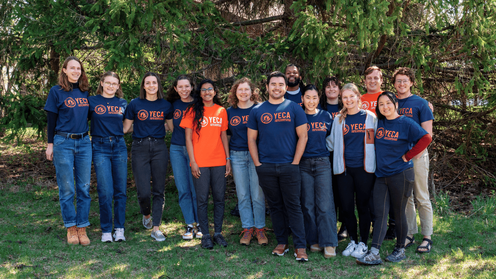 Group of young people outside in matching blue and orange YECA tshirts 