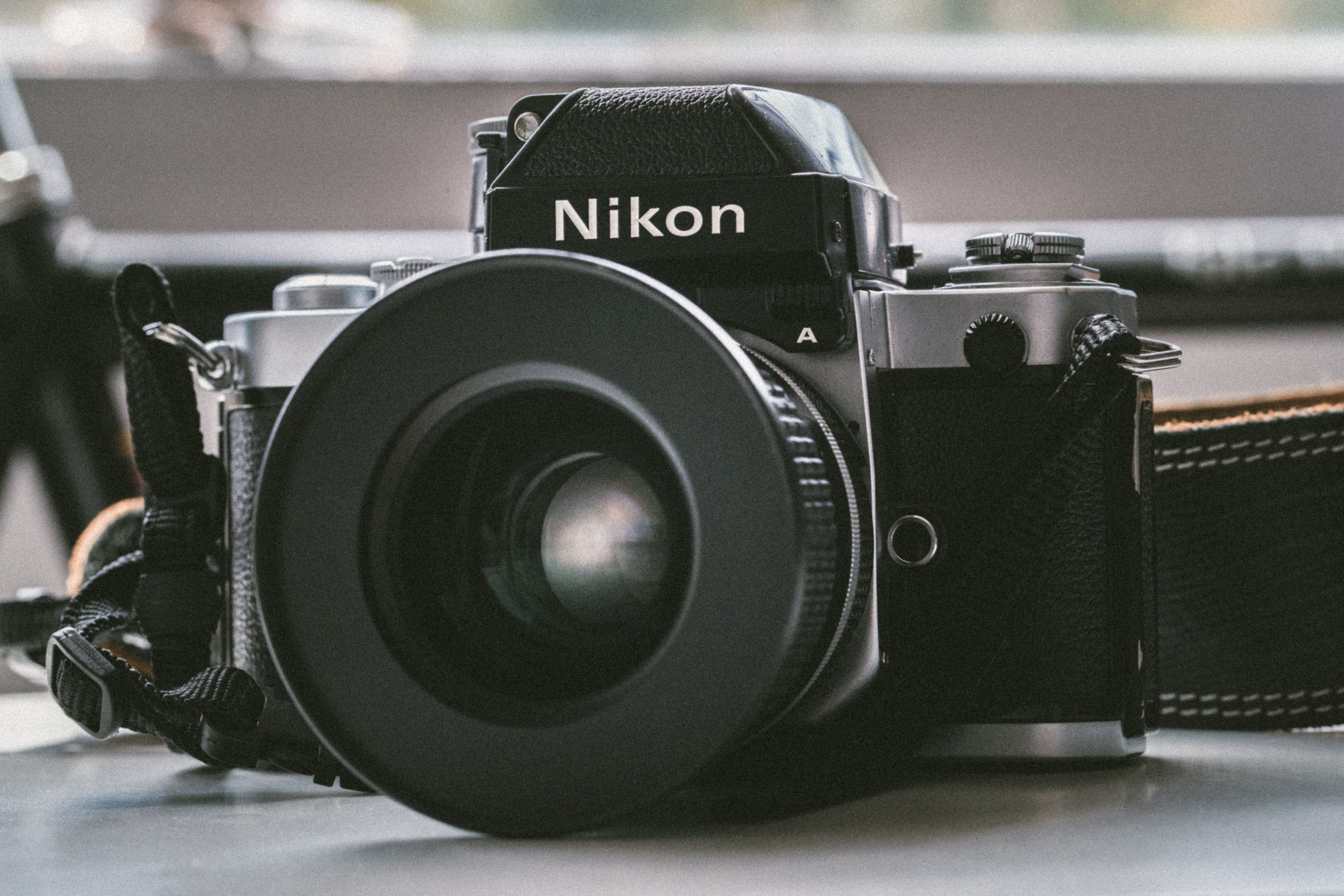Black Nikon camera placed on a table