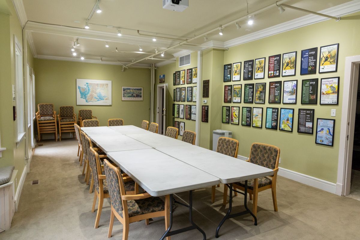 Several chairs set up around 6 long tables to mimic the conference style set-up for the Bird Fest Room.