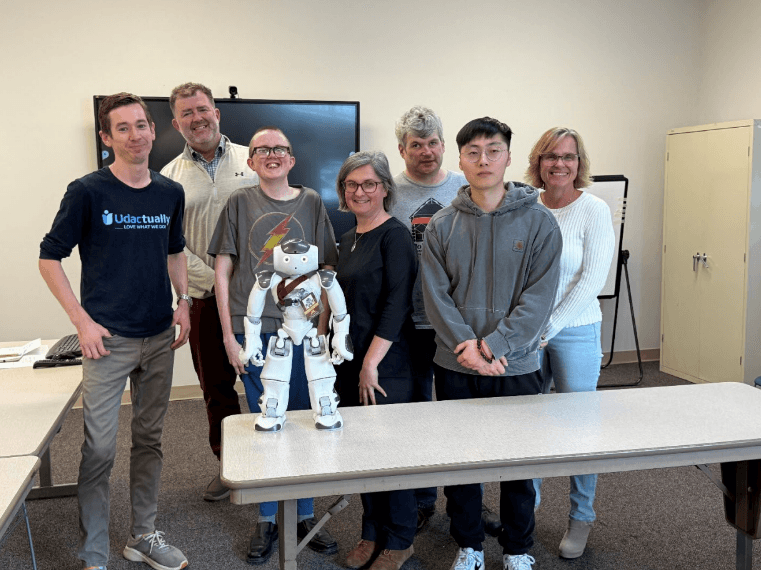 The Udac Technology Beyond an iPad Team surrounding Nao the humanoid robot