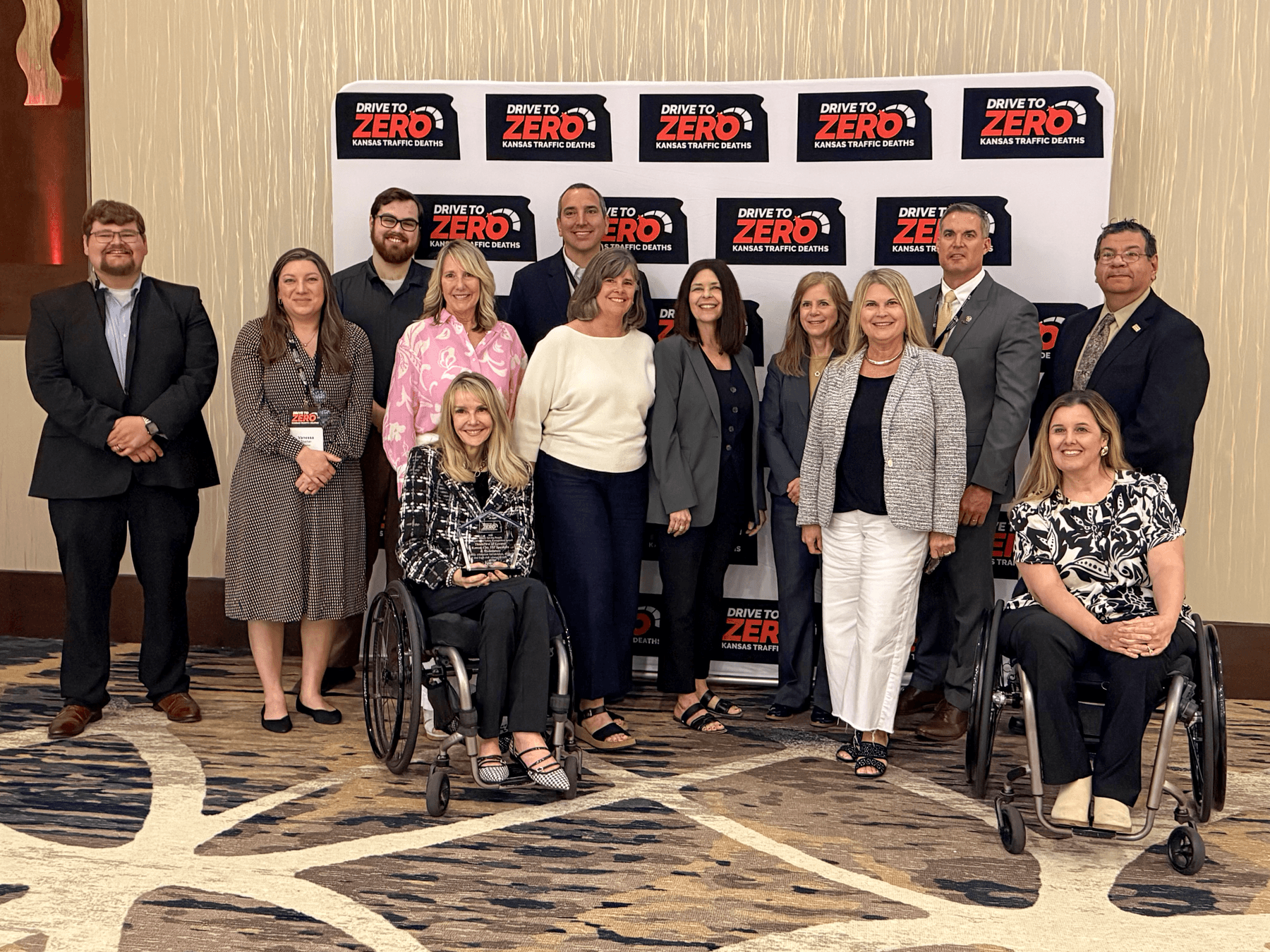 group of people posing with award