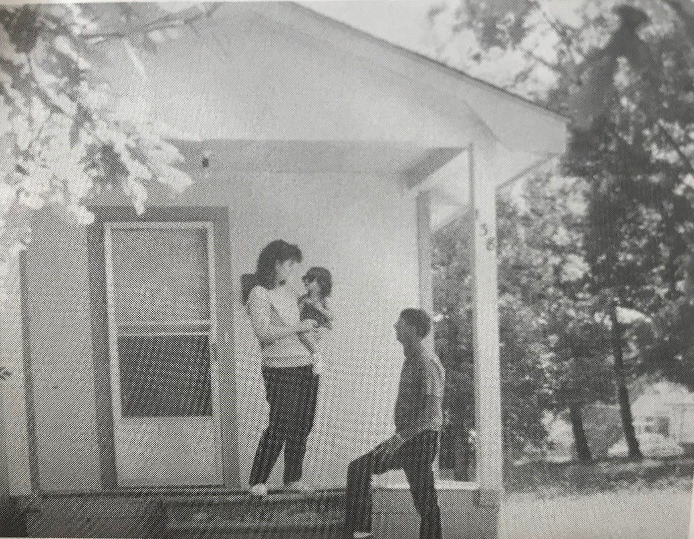 The Miller family stands on their front porch. 